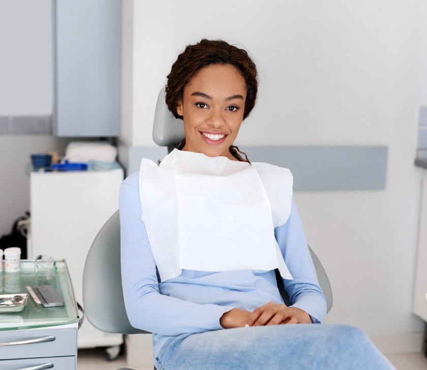 Woman smiling in dental chair during family dentistry visit