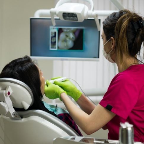 Dentist and dental patient looking at digital smile images