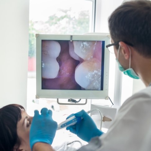Dentist capturing smile images using intraoral camera
