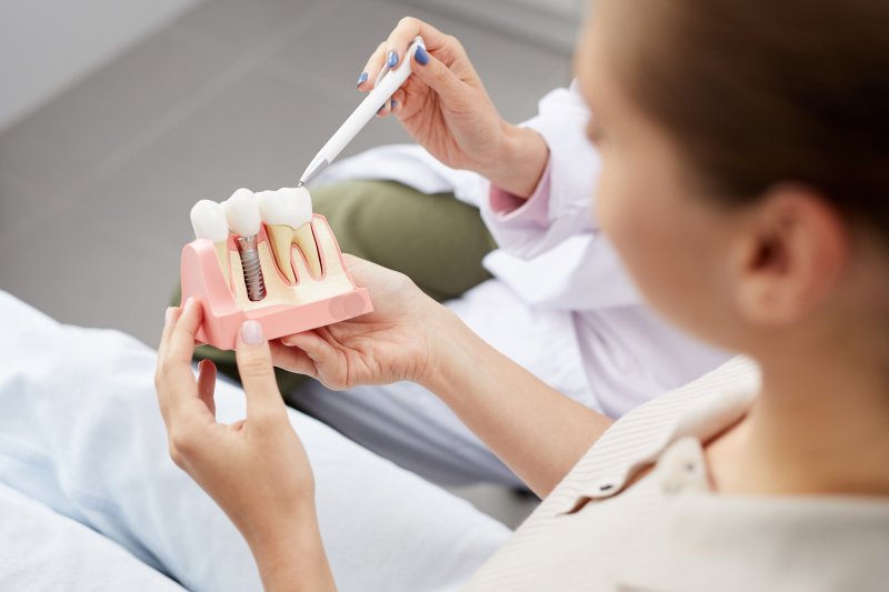 A dentist explaining dental implants in Brookfield to an out-of-focus patient