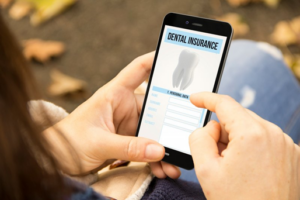 Woman looking at dental insurance details on her phone